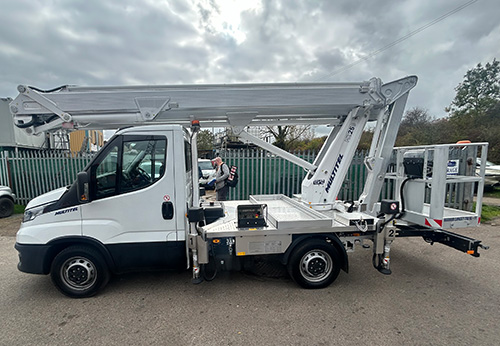 a white truck with a ladder attached to it mz250